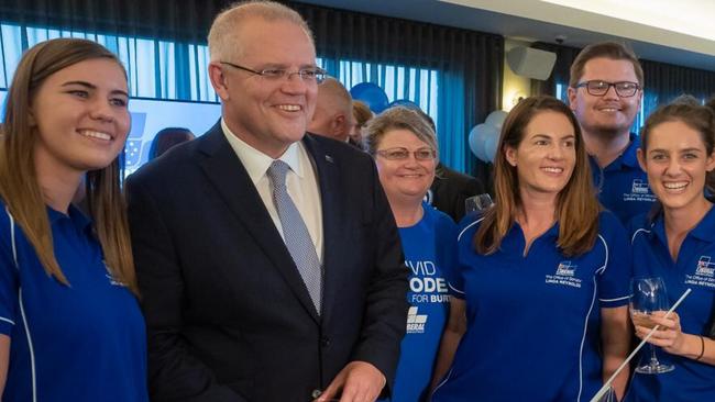 Higgins posing for a picture with Morrison and other staff.