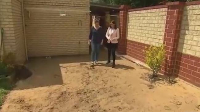 The workers tore up her backyard leaving it a mess of sand and mud. Picture: 9 News