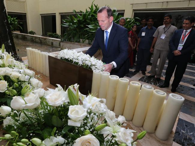 Prime Minister Tony Abbott lays a wreath at a memorial to those killed during a 2008 terrorist attack on the Taj Mahal Palace Hotel in Mumbai, India.