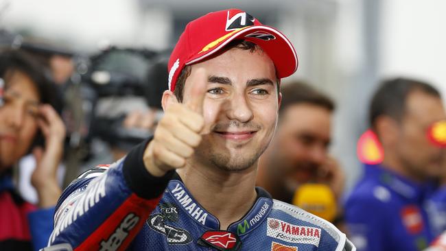 Spain's Jorge Lorenzo poses after taking pole position in the qualifying session for Sunday's MotoGP Japanese Motorcycle Grand Prix at the Twin Ring Motegi circuit in Motegi, north of Tokyo, Saturday, Oct. 10, 2015. (AP Photo/Shizuo Kambayashi)