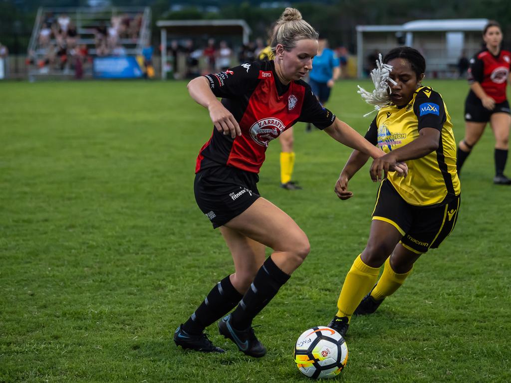 Leichhardt's Isobel Lukins charges into Edge Hill's Xena Faddy's defence in Saturday nights Women's FNQ Premier League grand finals at Endeavour Park. Picture: Emily Barker