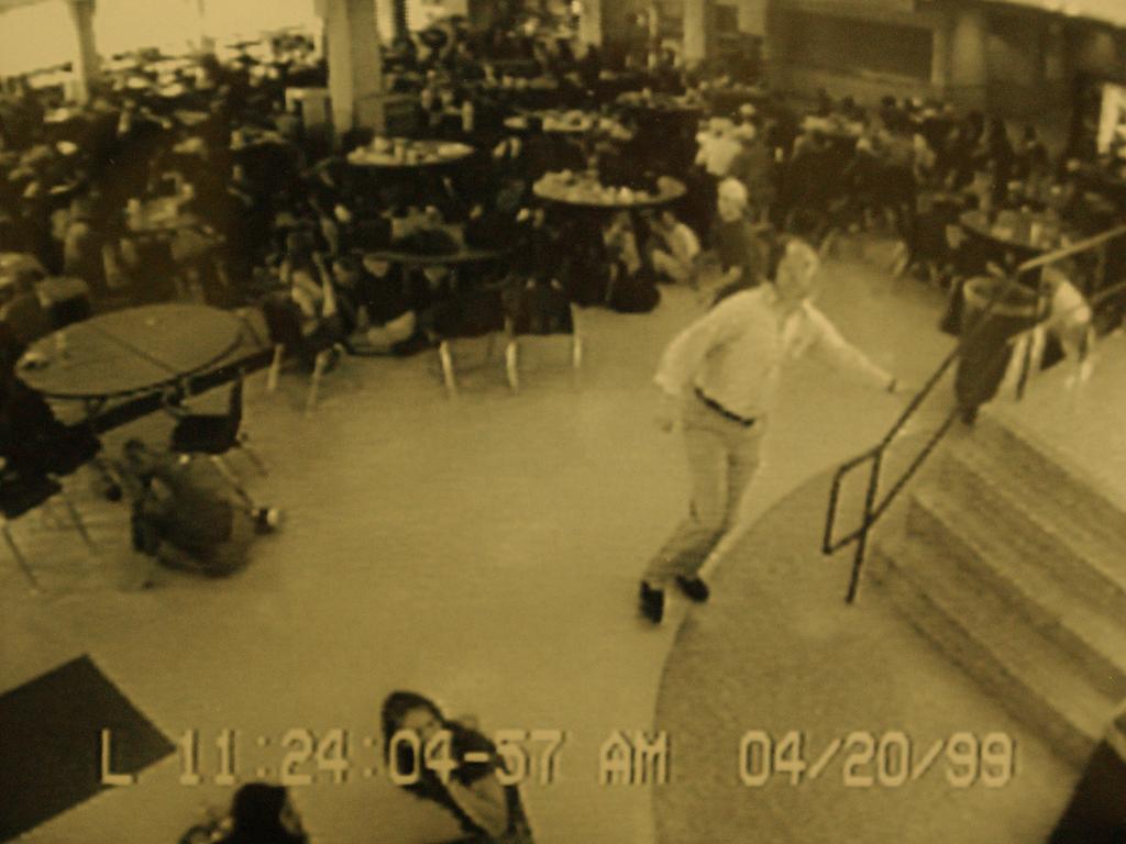 Video surveillance camera captured this image of business teacher Dave Saunders climbing the stairs out of the school cafeteria as students ducked beneath tables as the first shots rang out at the school. Picture: Karl Gehring/The Denver Post via Getty Images