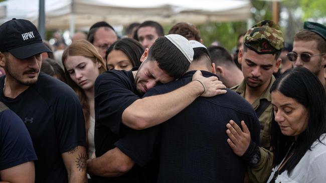 Relatives react during the funeral of an Israeli soldier killed in conflict with Hamas.