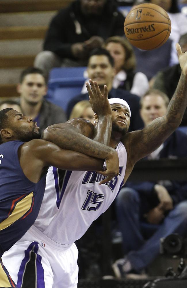 Sacramento Kings center DeMarcus Cousins, right, grabs a rebound against New Orleans Pelicans guard Tyreke Evans.