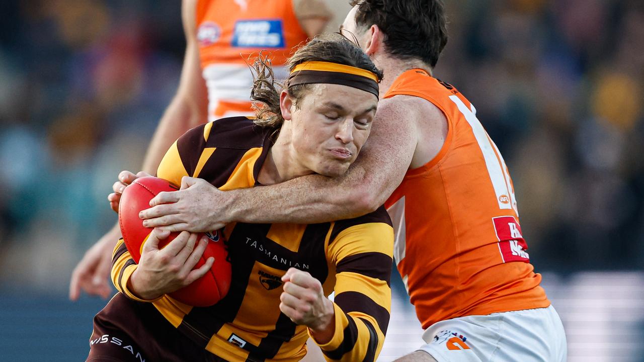 MELBOURNE, AUSTRALIA - JUNE 08: Jack Ginnivan of the Hawks receives a high tackle from Brent Daniels of the Giants during the 2024 AFL Round 13 match between the Hawthorn Hawks and the GWS GIANTS at UTAS Stadium on June 08, 2024 in Launceston, Australia. (Photo by Dylan Burns/AFL Photos via Getty Images)