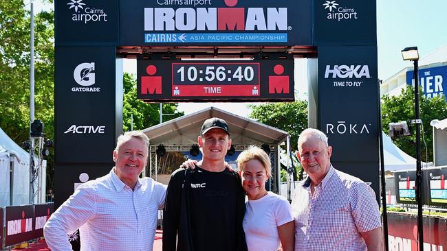 State MP for Cairns Michael Healy, Ironman Cairns two-time champion Max Nuemann, Ironman Cairns 2021 champion Kylie Simpson, and Cairns Regional Council's Cr Max O'Halloran at the finish line for the 2022 event.