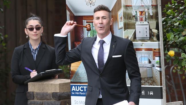 A Melbourne auction in March. A house price fall of 30 per cent plus would devastate the nation and consumer spending. Picture: David Crosling