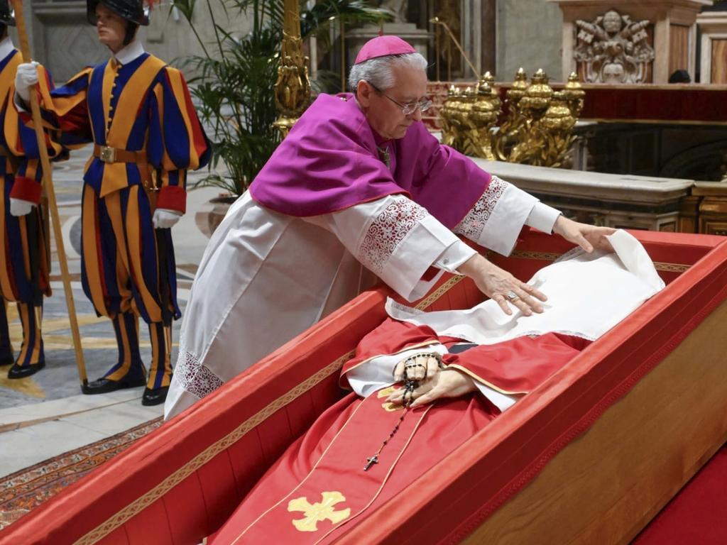 Vatican Master of Ceremonies Archbishop Diego Giovanni Ravelli covers the face of late Pope Francis with a silk cloth before closing his casket in St. Peter's Basilica at the Vatican. Picture: AP