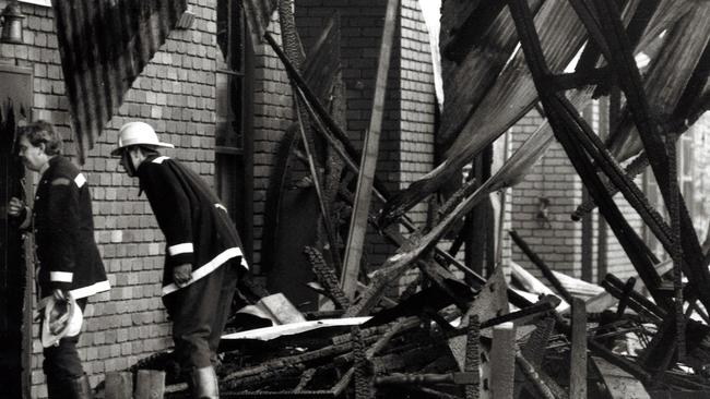 Firemen inspect the smouldering ruins of The Swagman restaurant in Ferntree Gully after it was destroyed by fire.