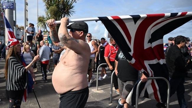 Protesters wave Union Jack flags as far-right activists hold a demonstration on Sunday in Weymouth, Dorset. Picture: Finnbarr Webster/Getty Images