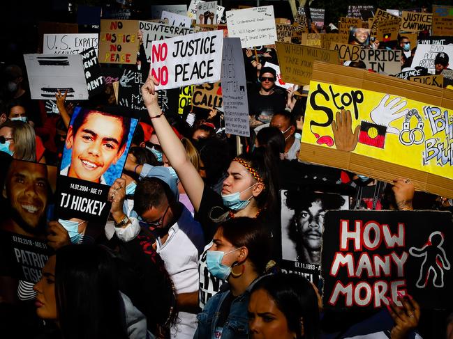 Protesters hold up signs in Brisbane yesterday. Picture: AFP