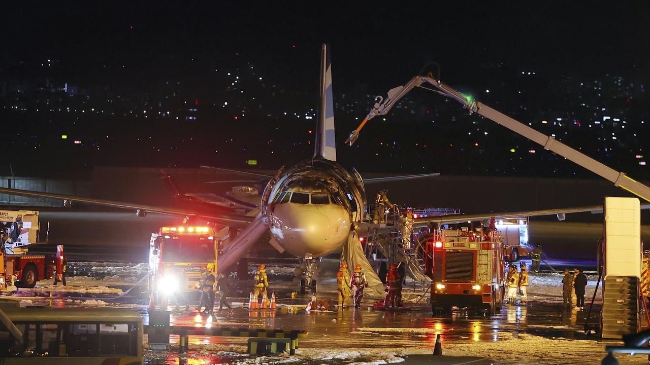 Firefighters work to extinguish a fire on an Air Busan. Picture: Son Hyung-joo/Yonhap via AP