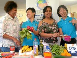 Theresa Stanke, Yngli Zhang, Dheepa Arumuga and Bing Xiong from QCMA prepare for taste of the World at the Showgrounds. Picture: Jann Houley