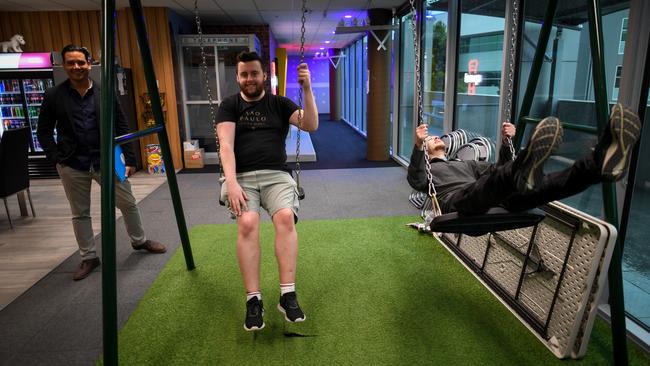 Aaron Villa and Steve Morris have a go on the swings during a tour of VentraIP Australia’s workplace. Picture: Penny Stephens