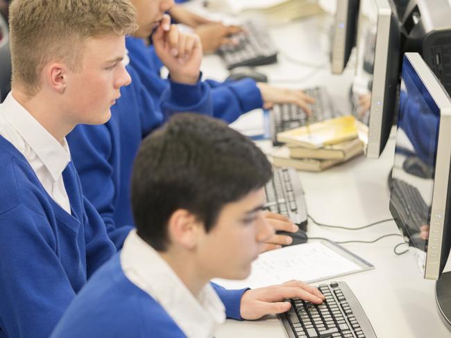 Schools of excellence - teenage students using computers in computer room.