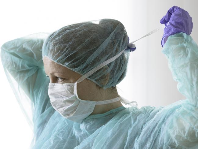 Nurse wearing protective mask and gloves. New coronavirus Covid-19 from China. Female surgeon wearing her surgical mask