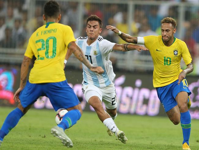 Brazil's forward Neymar (R) fights for the ball with Argentina's midfielder Giovani Lo Celso (C) during the friendly football match at the King Abdullah Sport City Stadium in Jeddah.