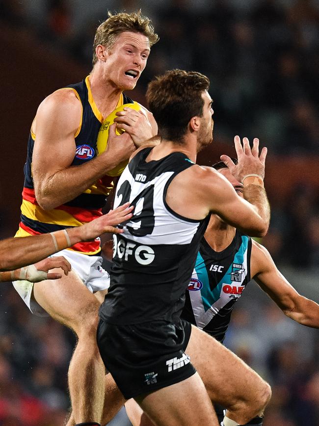  Alex Keath takes a strong grab under pressure from Port big man Scott Lycett. Picture: Daniel Kalisz/Getty Images