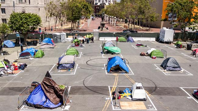 Rectangles are painted on the ground to encourage homeless people to keep social distancing at a city-sanctioned homeless encampment across from City Hall in San Francisco. Picture: AFP