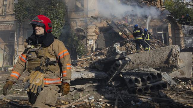 Firefighters appear on the scene to put out a fire after a kamikaze drone attack in Kyiv on October 17. Picture: Getty Images