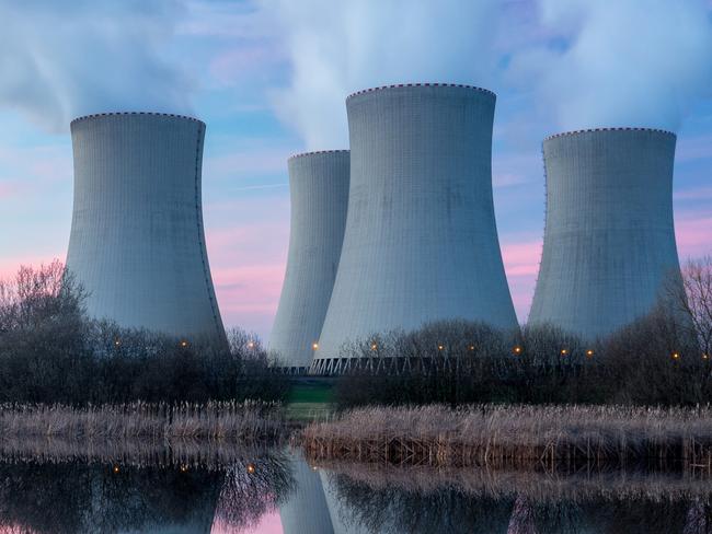 Nuclear power plant after sunset. Dusk landscape with big chimneys.