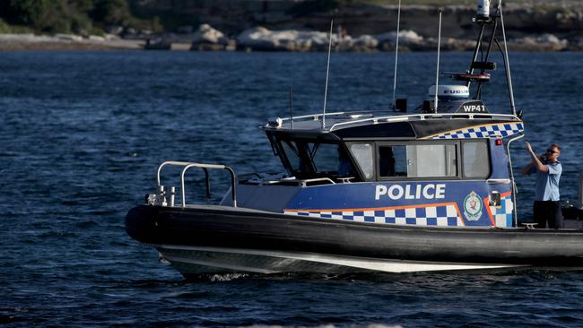 A police boat searches the water at Yarra Bay. Picture: Damian Shaw