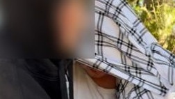 Nathan Bernhard leaving Nowra Police Station, hidden under blanket. Picture: Tom McGann