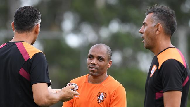 Henrique speaks with coach John Aloisi (left)