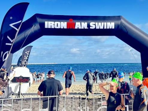 An athlete has died after being pulled from choppy waters during a gruelling Ironman triathlon in WA.