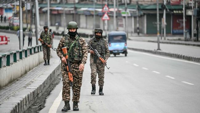 Indian paramilitary soldiers patrol along a road in Srinagar on Saturday. Picture: Sajjad Hussain / AFP