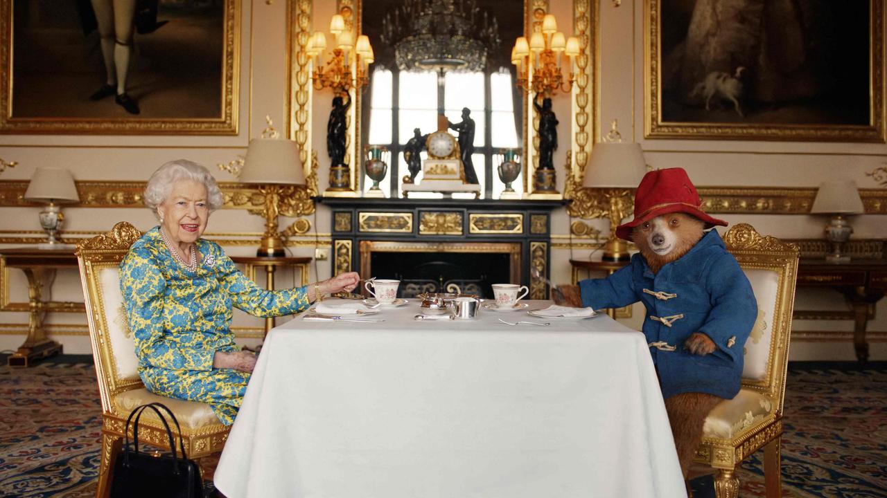 The Queen takes cream tea at Buckingham Palace with Paddington Bear in a film shown at the BBC Platinum Party at the Palace on June 4, 2022. Picture: Buckingham Palace / AFP