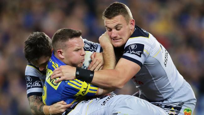 Eels lock Nathan Brown is wrapped up by the Cowboys defence.