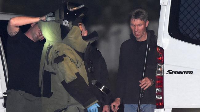 A bomb squad expert suits up to explore Endeavour Hills police station. Picture; Mike Keating