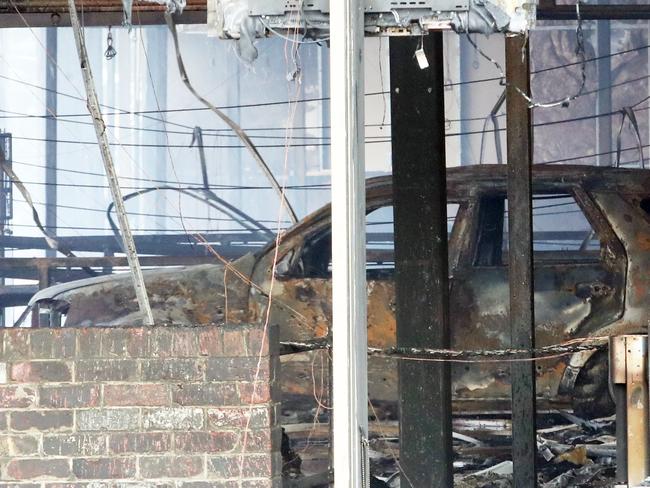 A burnt-out car is seen inside the building. Picture: David Crosling