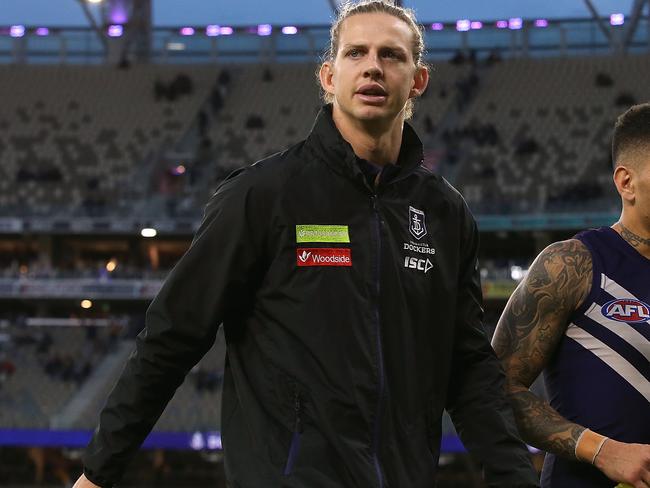 PERTH, AUSTRALIA - JULY 01: Nathan Fyfe and Michael Walters of the Dockers walk from the field after being defeated during the round 15 AFL match between the Fremantle Dockers and the Brisbane Lions at Optus Stadium on July 1, 2018 in Perth, Australia.  (Photo by Paul Kane/Getty Images)