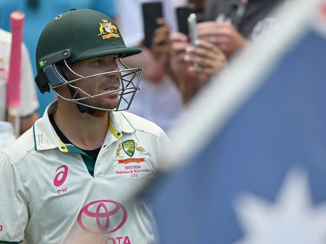 Australia's David Warner walks out to bat during his 112th and final Test on day four of the third cricket Test match between Australia and Pakistan at the Sydney Cricket Ground in Sydney on January 6, 2024. (Photo by Saeed KHAN / AFP) / -- IMAGE RESTRICTED TO EDITORIAL USE - STRICTLY NO COMMERCIAL USE --