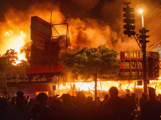 Protesters gather in front of a liquor store in flames near the Third Police Precinct on May 28 in Minneapolis, Minnesota, during a protest over the death of George Floyd. Picture: AFP