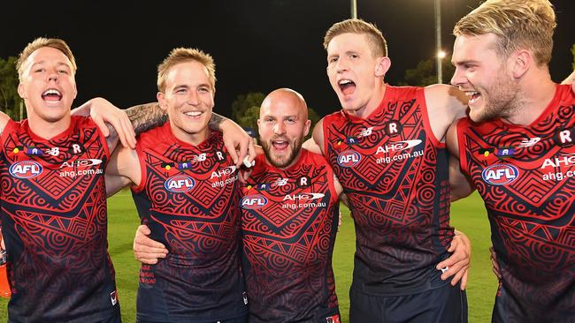 ALICE SPRINGS, AUSTRALIA - MAY 27:  James Harmes, Bernie Vince, Nathan Jones, Sam Frost and Jack Watts of the Demons sing the song after winning the round ten AFL match between the Melbourne Demons and the Gold Coast Suns at Traeger Park on May 27, 2017 in Alice Springs, Australia.  (Photo by Quinn Rooney/Getty Images)