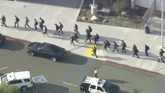 People are lead out of Saugus High School after reports of a shooting. Picture: AP