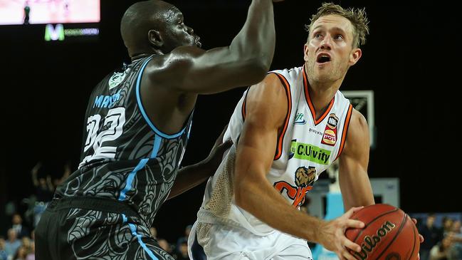 Mitchell Young of the Taipans is challenged by Majok Majok of the Breakers on Friday night. Picture: AAP