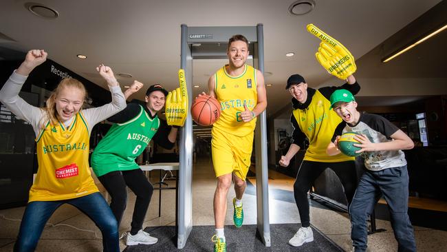 Boomers guard Matthew Dellavedova uses the magnetometer cheered on by fans Darci, Zac, Kobe and Jude. Picture: Jason Edwards