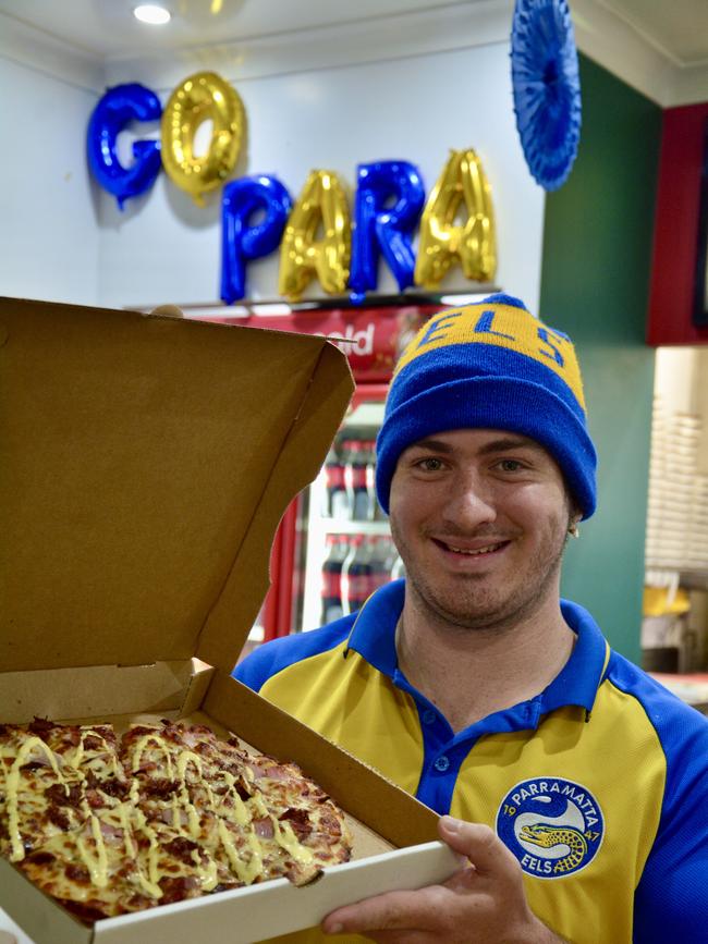 Eels fan Christian Morrison, from Shoal Point, is excited about getting tickets to the NRL semi-finals in Mackay on the weekend. Ma's Pizza, where he works, is preparing to sell 2000 slices of pizza during the two semi-final games. Picture: Rae Wilson