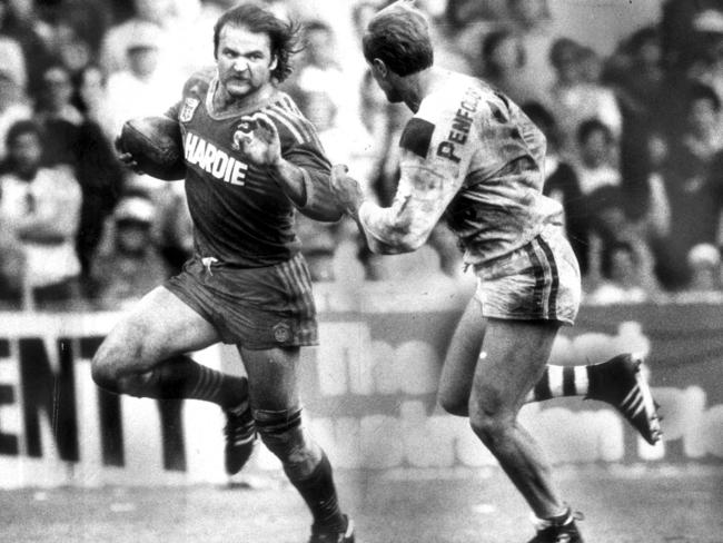 Eric Grothe Snr runs away from Brian Johnston during a Parramatta Eels versus St George Dragons semi-final game in 1984. Picture: Anthony Weate.