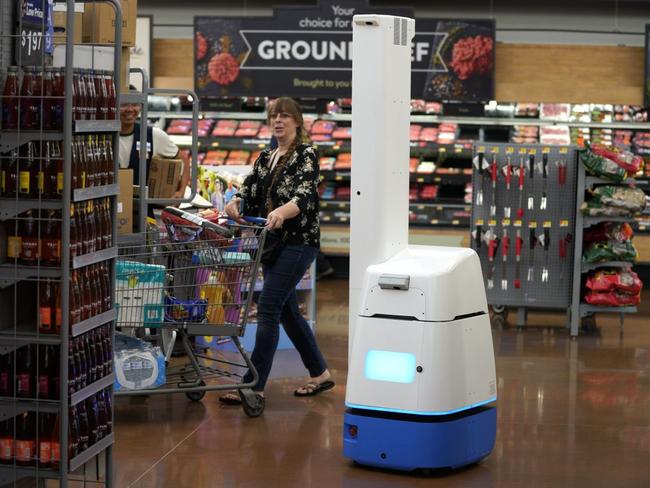 An automated shelf scanner is among the robots that Walmart is introducing into its stores. PHOTO: RICK T. WILKING/GETTY IMAGES