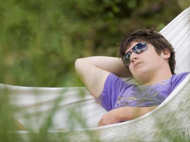 Teenage boy asleep in a hammock