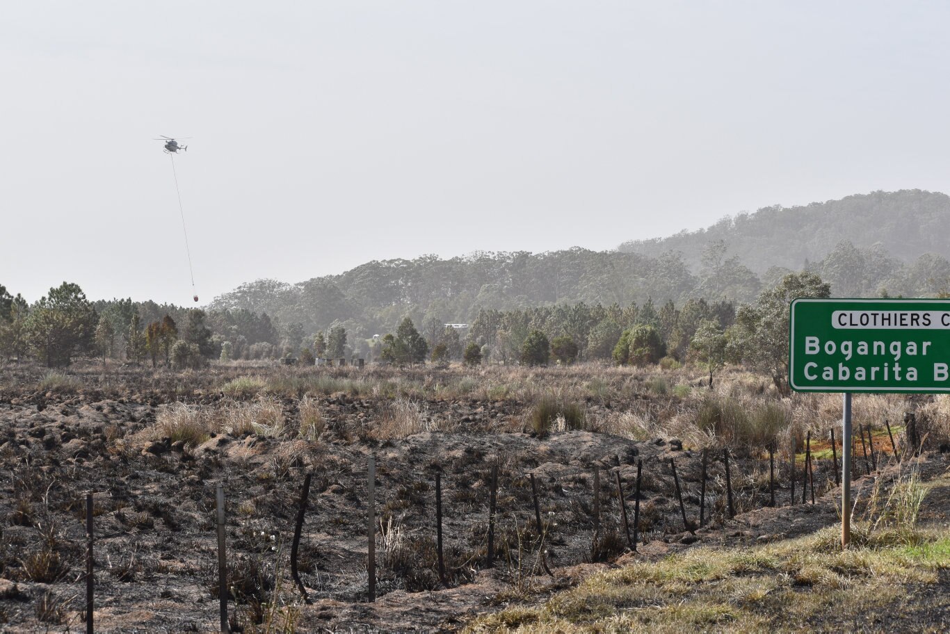 Firefighting helicopters waterbombing the fire at Duranbah.