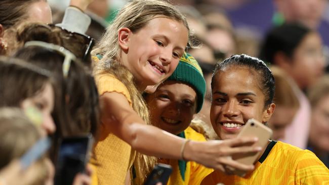 PERTH, AUSTRALIA - NOVEMBER 01: Mary Fowler of the Matildas poses for selfies with fans after the AFC Women's Asian Olympic Qualifier match between Australia and Chinese Taipei at HBF Park on November 1, 2023 in Perth, Australia. (Photo by Will Russell/Getty Images)