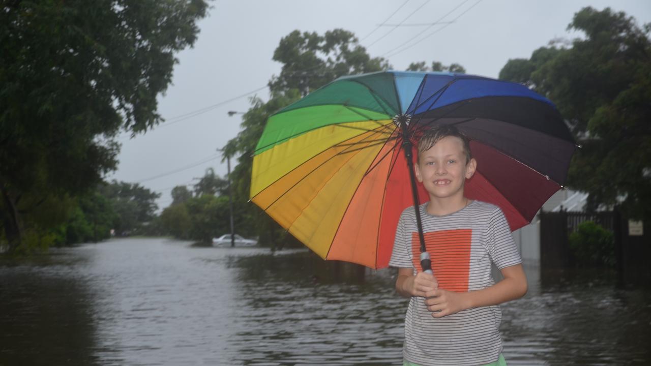 Cooper Nicholson in flood of the flooded water at Sherriff St, Hermit Park. Photo: Chris Lees