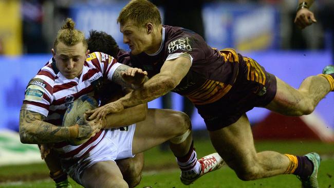 WIGAN, ENGLAND - FEBRUARY 21: Josh Charnley of Wigan Warriors is tackled by Aaron Whitchurch of Brisbane Broncos during the World Club Series match between Wigan Warriors and Brisbane Broncos at DW Stadium on February 21, 2015 in Wigan, England. (Photo by Gareth Copley/Getty Images)