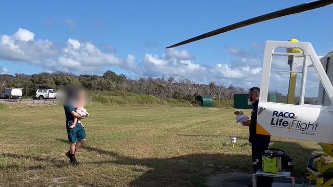 Paramedics take the boy, 2, into the RACQ Lifeflight helicopter. Picture: RACQ Lifeflight